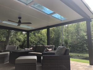 Website solid panel patio cover with skylights PAV StdioSkyV Attch Flor Bz Outsd Day LBL MI 0006