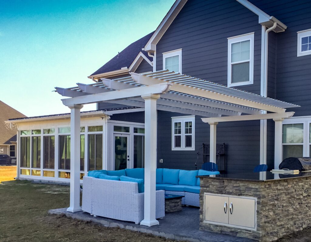 Enjoy this combo space year round with a stunning pergola and glass enclosed sunroom