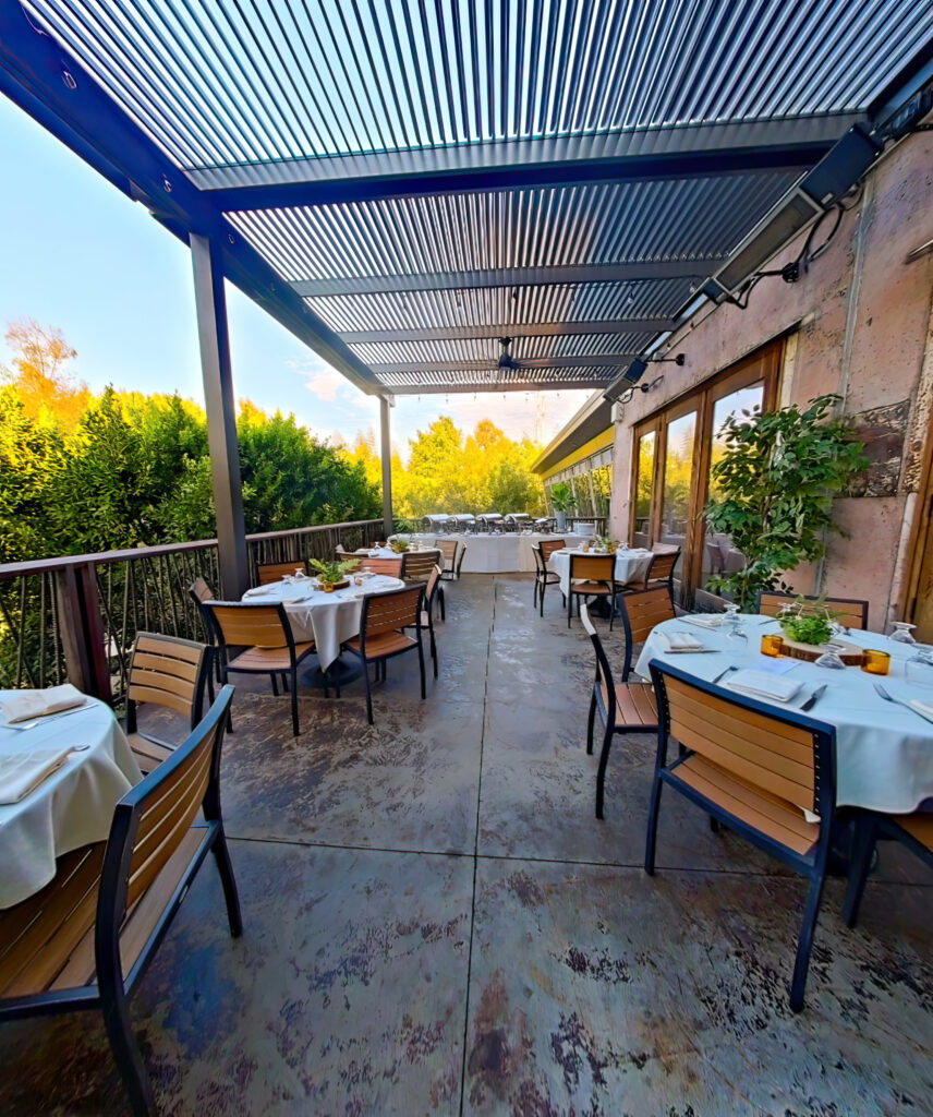 Adding a Motorized Pergola creates a cozy space for guests to dine and relax with protection from the hot sun or rain